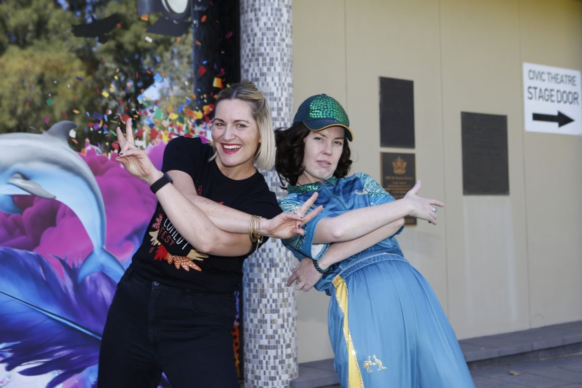 A Council staff member stands with a performer in a Australian Olympics uniform.