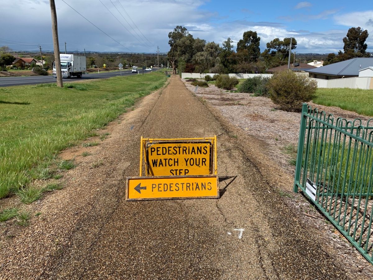 footpath, road verge, truck on road