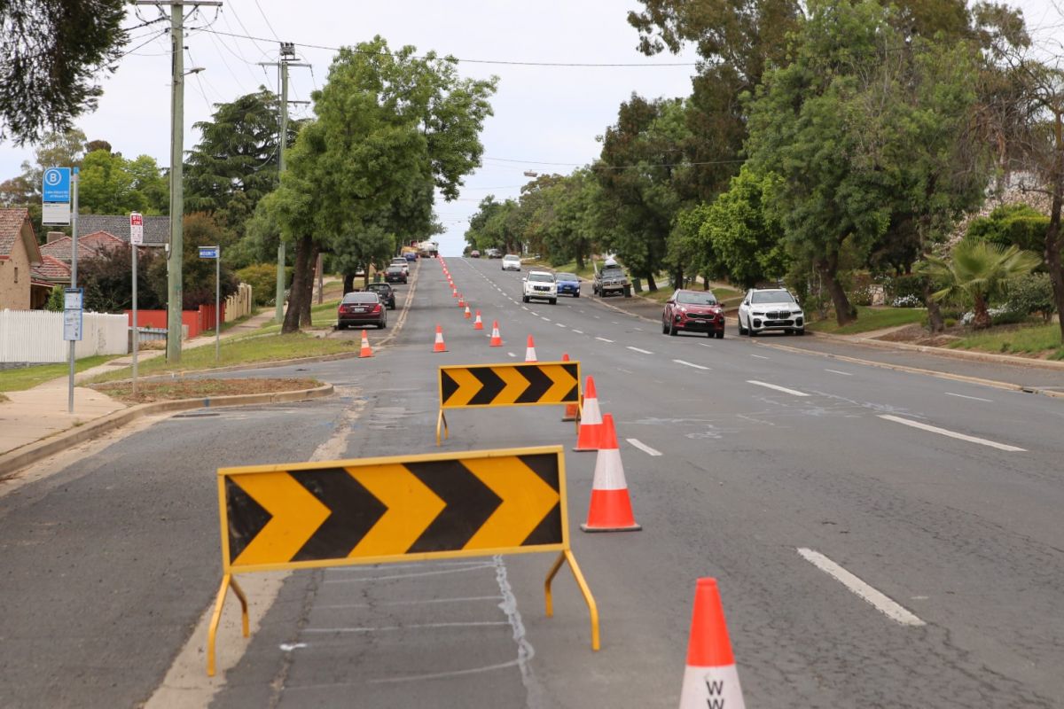 Safety barriers and witches hat closing off lane of road