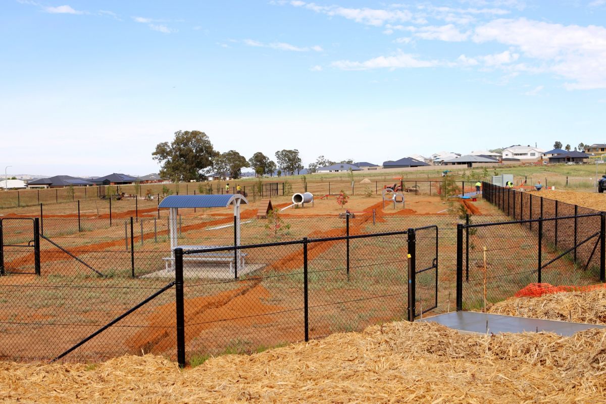 Dog agility equipment in fenced off-leash area