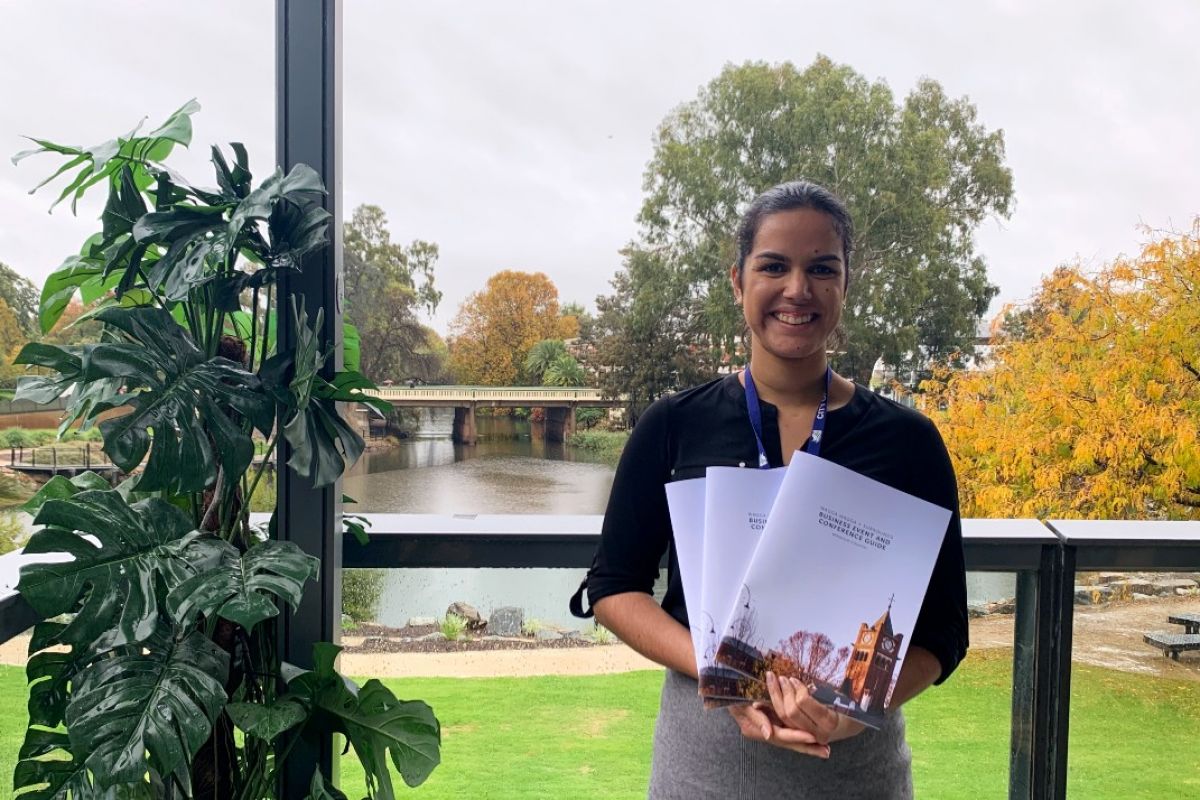 Woman holding guides with lagoon in background