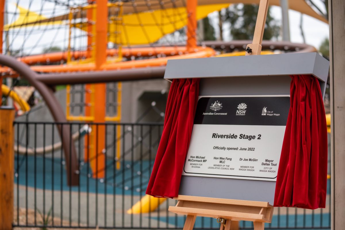 Unveiled plaque with playground in background