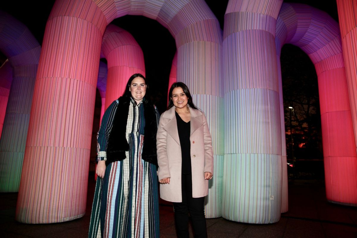 (from left) Events Officer Emma Corbett and Destination and Events Coordinator Kimberly Parker experience the dreamy Sky Castle installation at dusk.