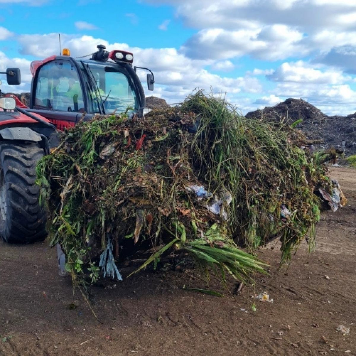 Tractor scoop of FOGO waste at the tip
