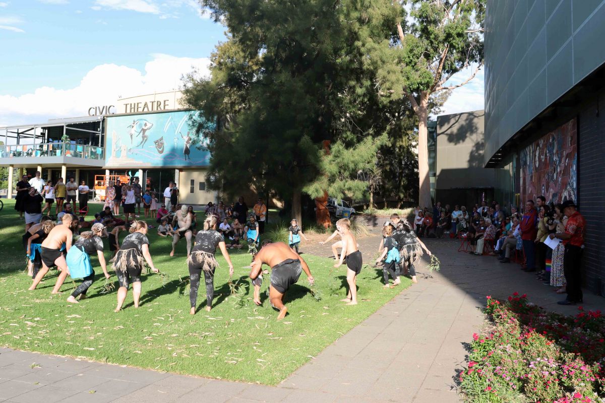 Wiradjuri and First Nations dancers on lawns beside library