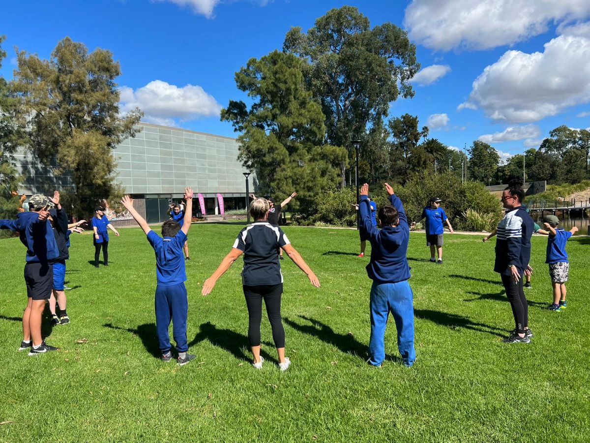 Students in circle on lawn near Civic Theatre