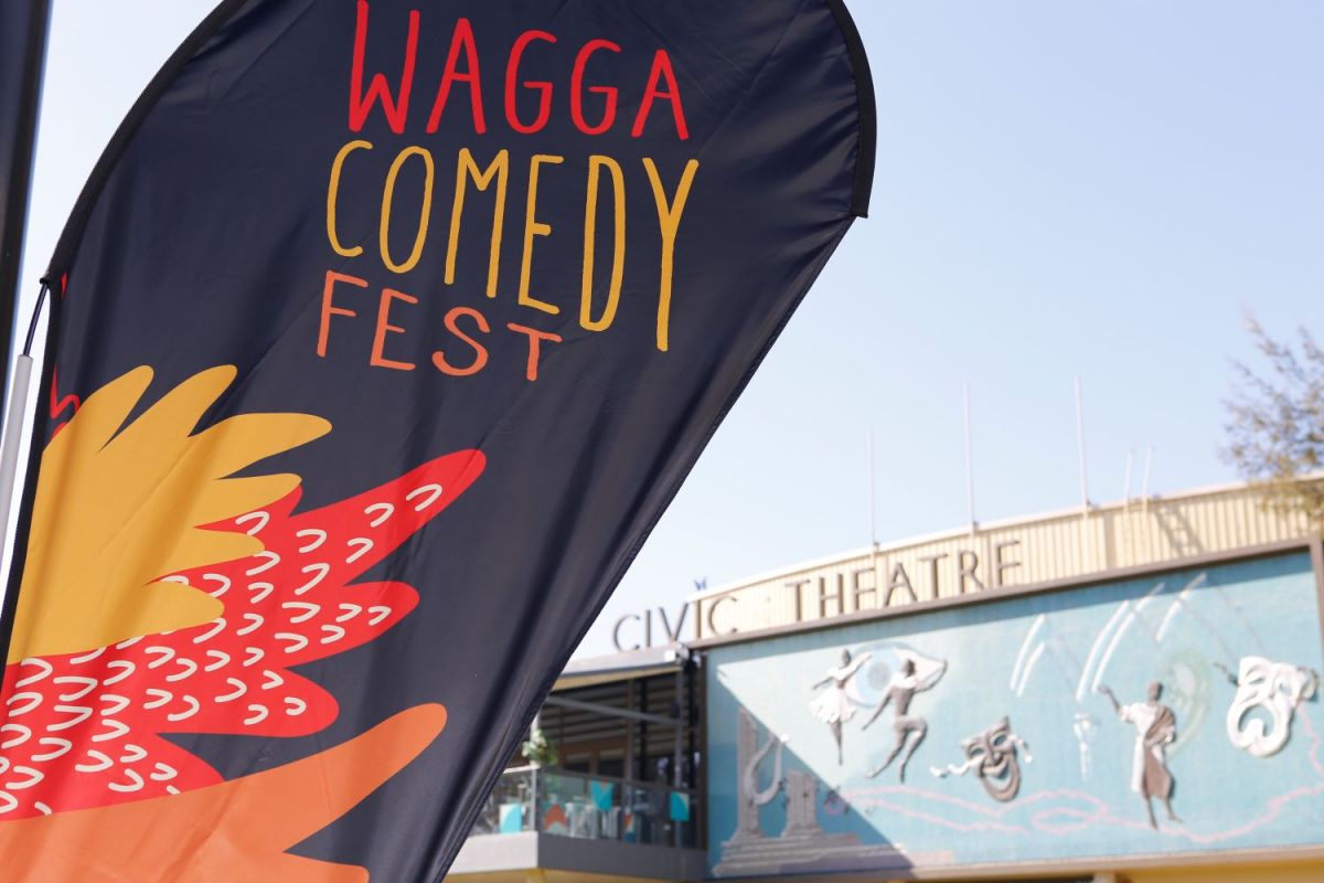 The Wagga Comedy Fest flag with the Wagga Civic Theatre building façade in the background. 