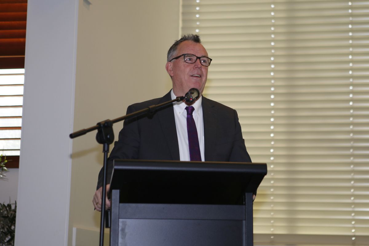 Close up of the Mayor of the city of Wagga Wagga Councillor Dallas Tout delivering his welcome speech at a podium.