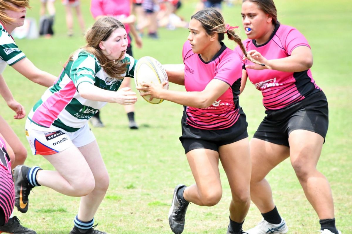 Young female rugby players on the field during a Super 7s game in Wagga Wagga