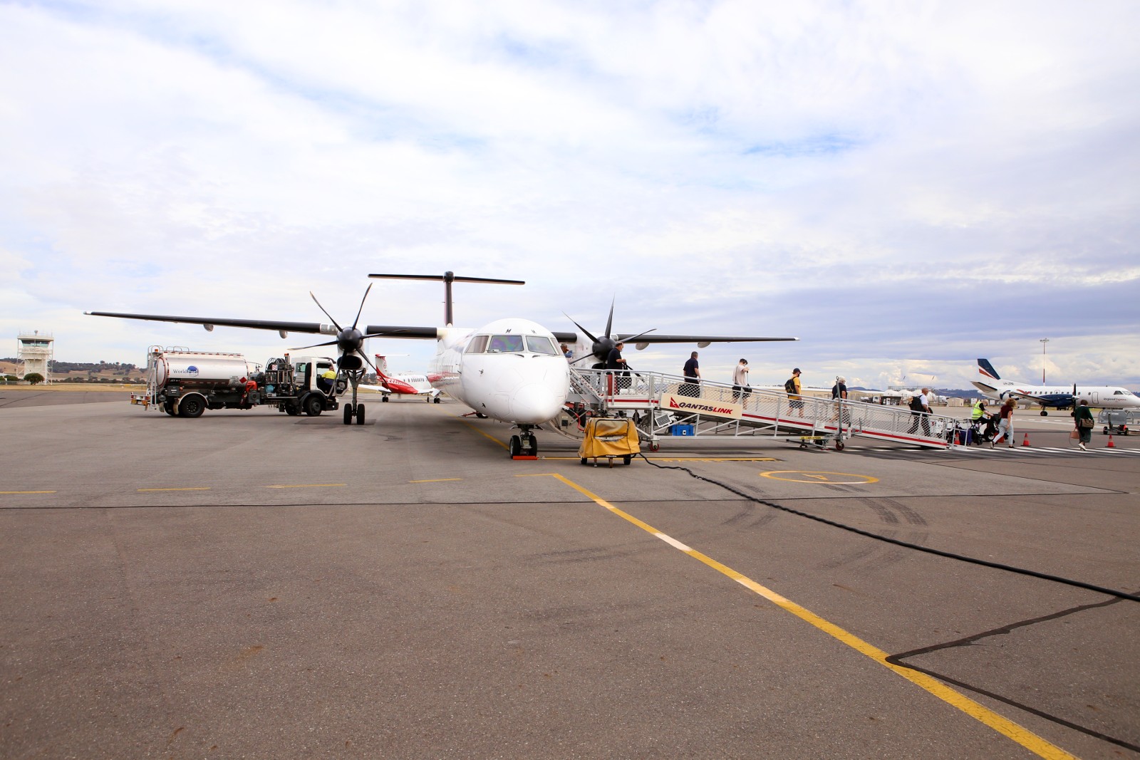 Passengers disembarking from a QantasLink aircraft on the Apron at Wagga Wagga Airport