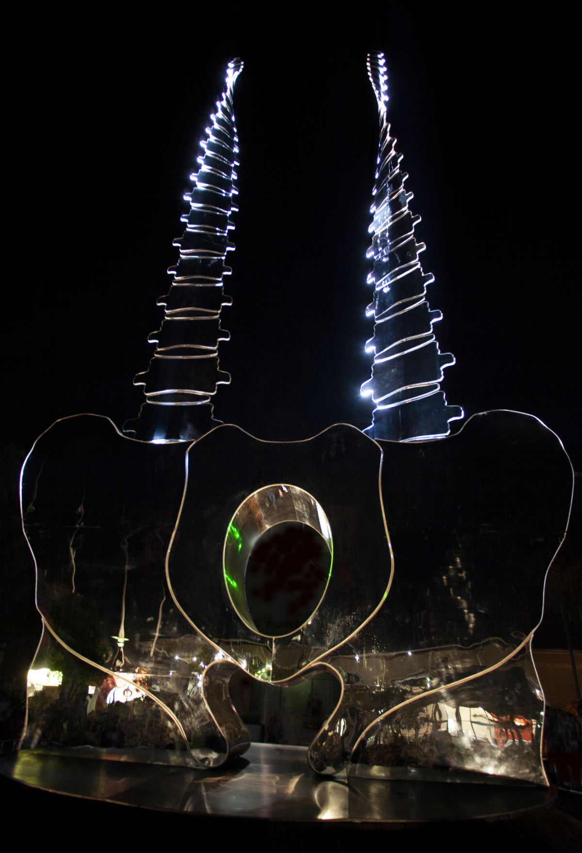 Mirrored sculpture lit up at night