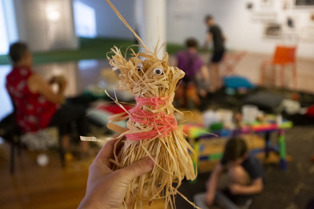 Creative pet made with raffia, sticks and googly eyes 