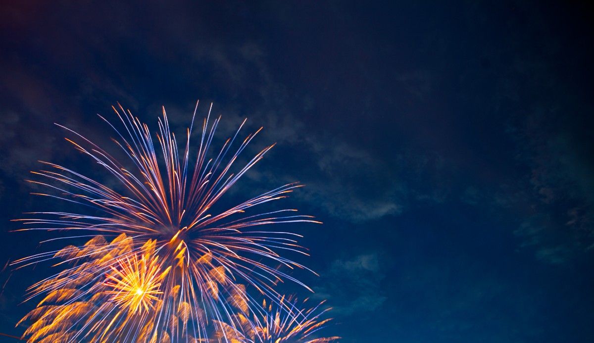 Fireworks explode in a night sky