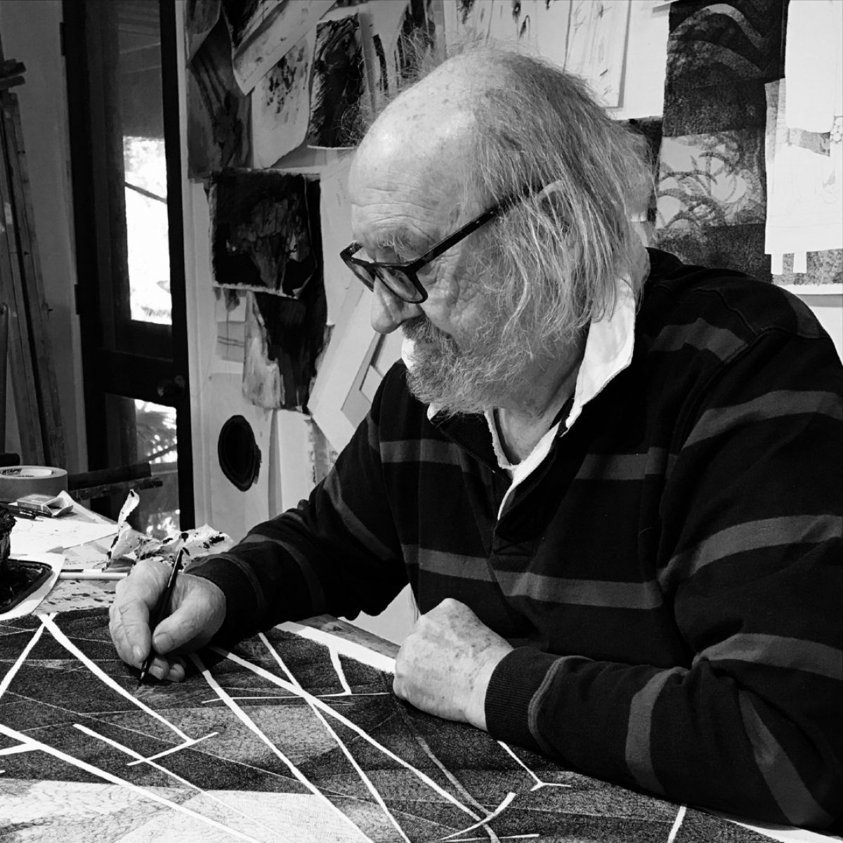 Black & white image of male artist in studio
