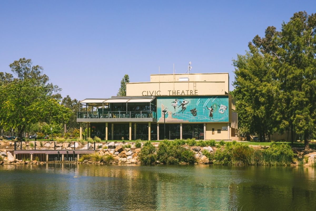 Civic Theatre in daytime with lagoon in foreground