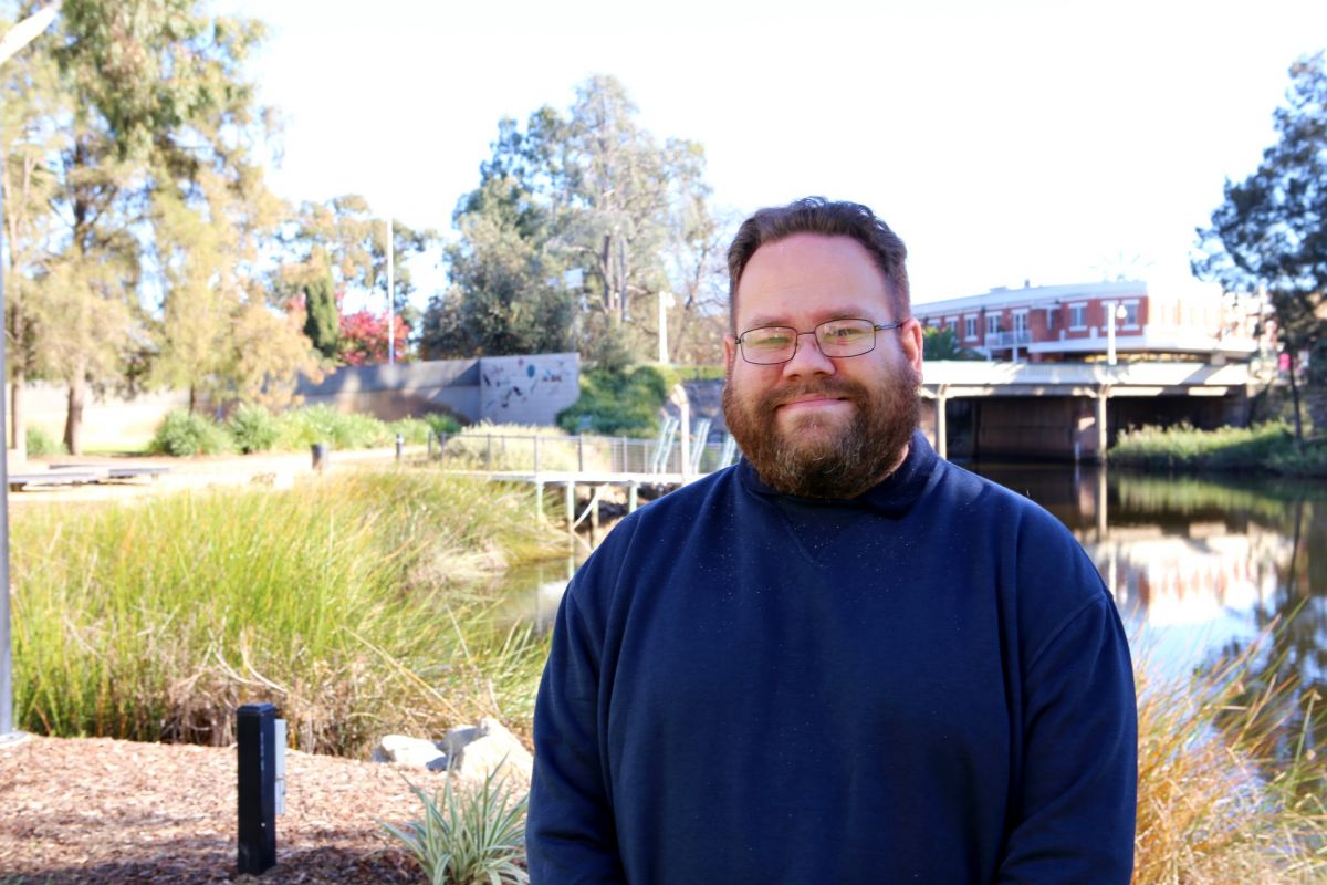 Man standing next to lagoon