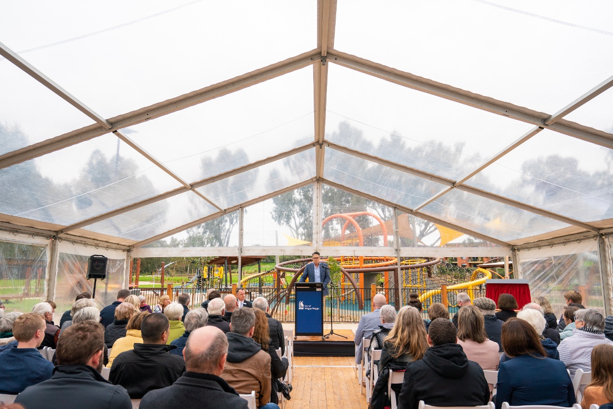 People seated under marquee at Riverside Stage 2 opening