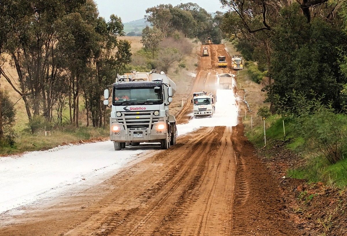 Trucks laying lime on Dunns Road