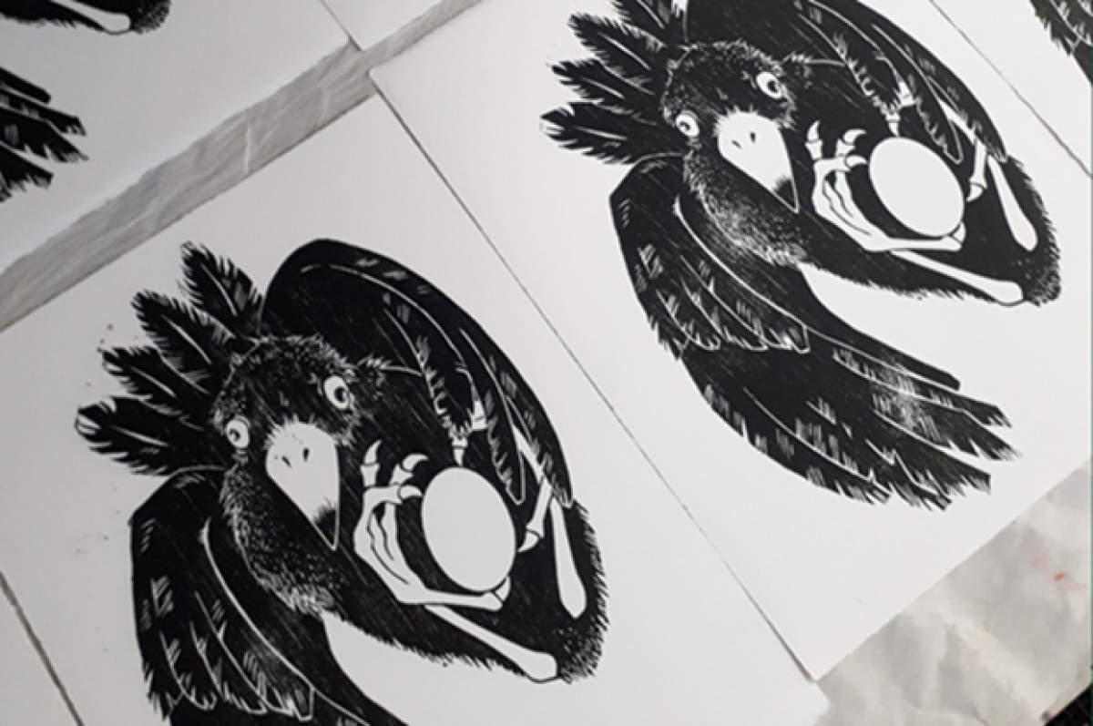 A close-up of some prints of birds on paper. 