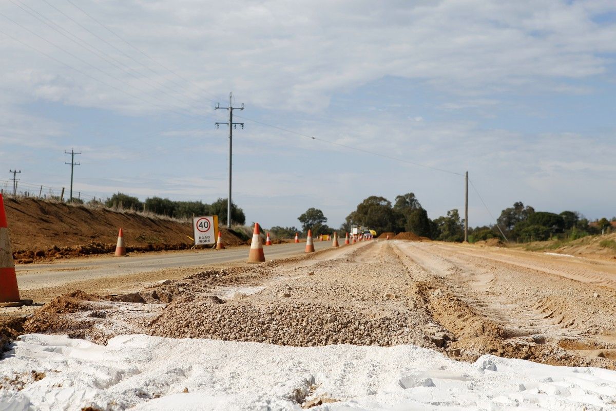 Road with right hand lane stabilised, safety cones and 40 kilometre per hour sign