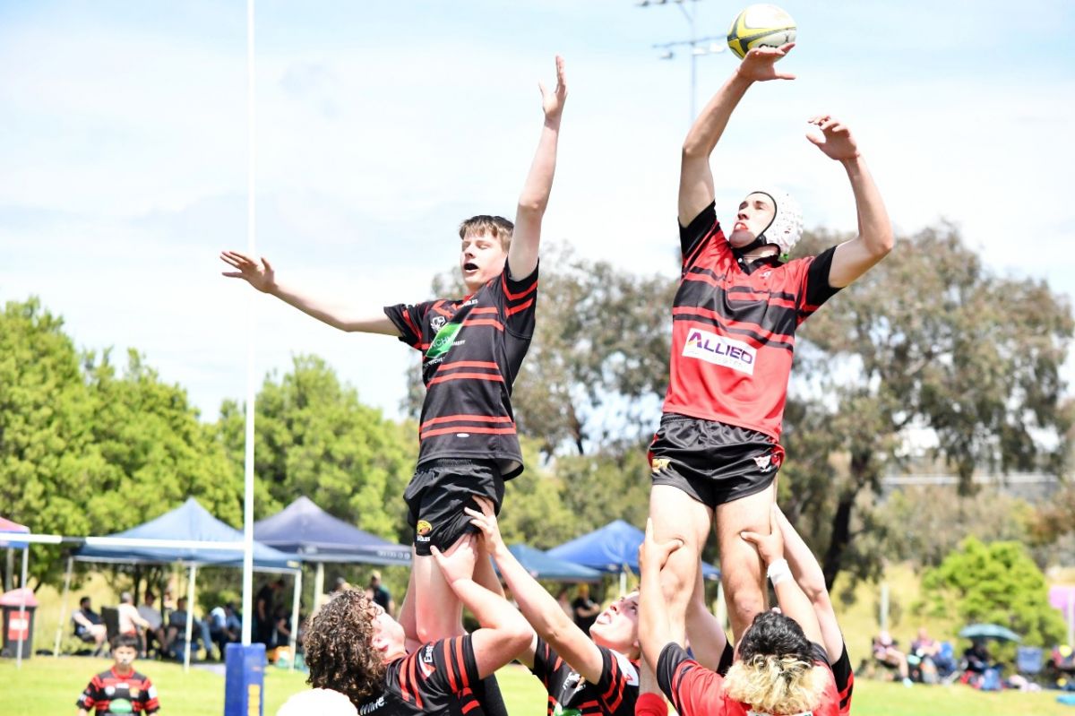 Young male rugby players in line out during Super 7s game.