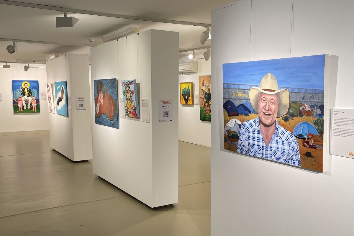 An art gallery space with portrait paintings on the walls. 
