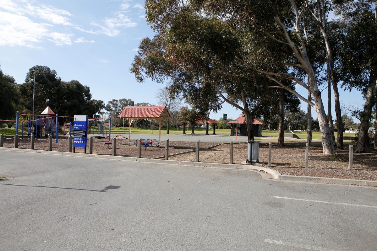 Car park next to playground, with netball court in background