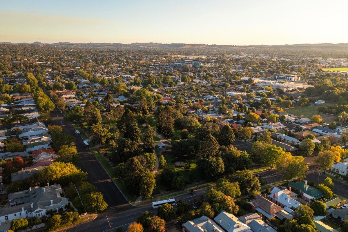 Aerial of residential suburbs, with houses surrounding a park.