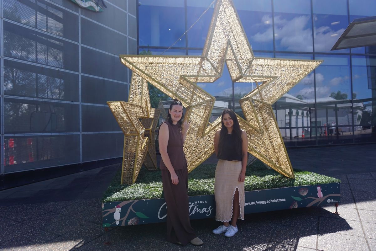 Events Officer Emma Corbett and Destination & Events Coordinator Kim Parker with Xmas stars in Civic Centre forecourt.