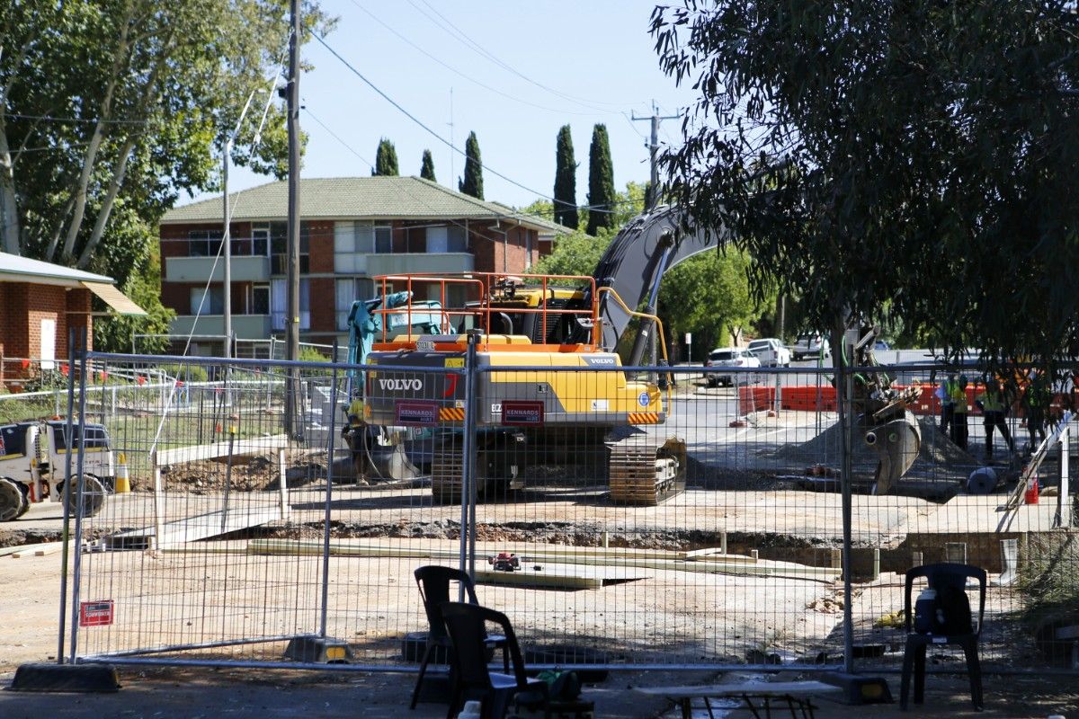 Heavy earth machinery working on a bridge on a road construction site.