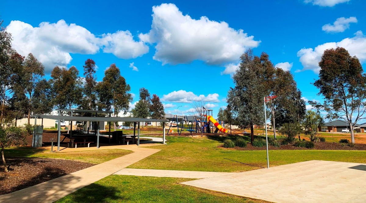 A park with play equipment and basketball court