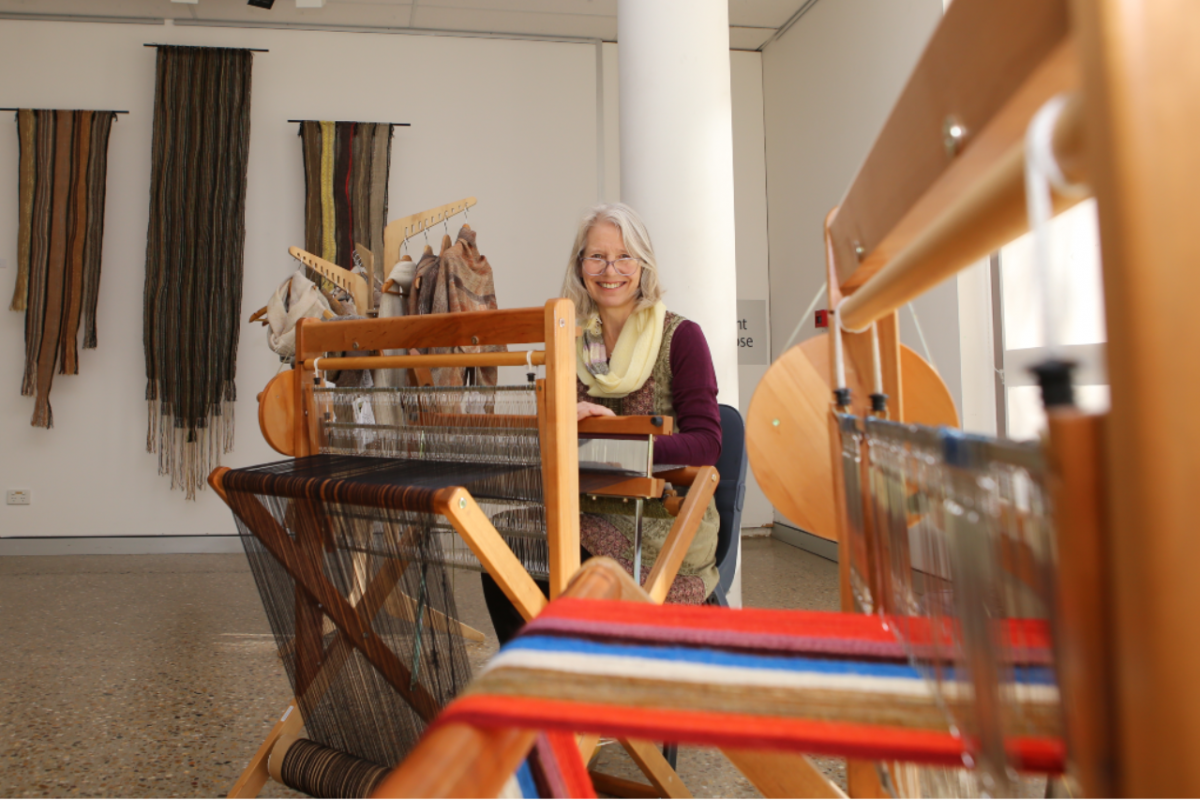 Woman sitting at a loom