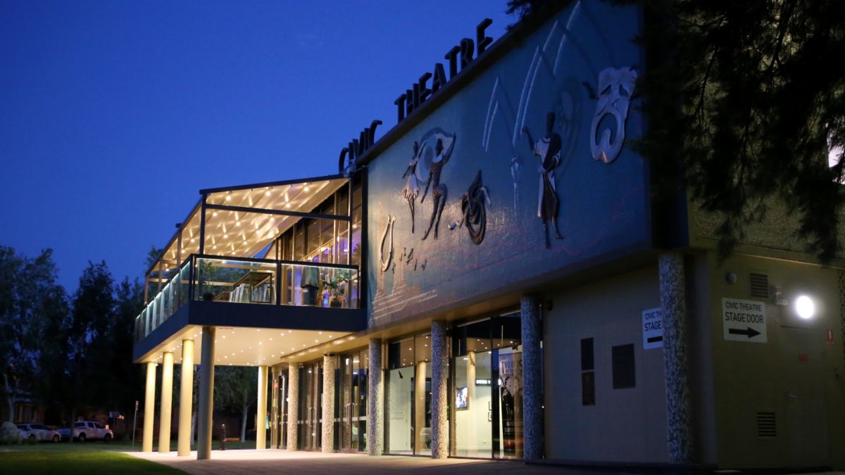 Theatre front entrance with portico, at night time