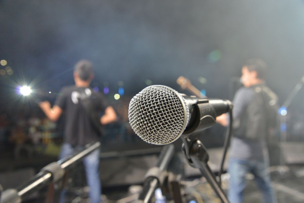 microphone in foreground with male band members in background