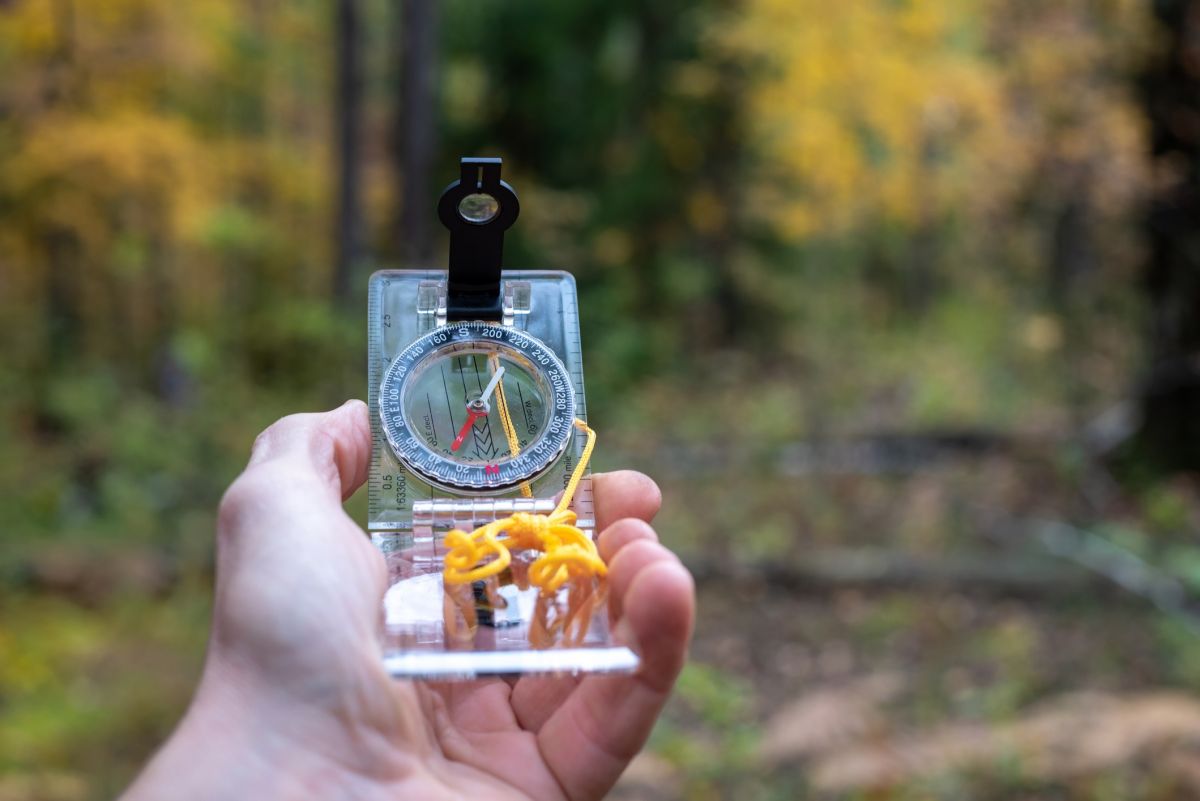 Hands holding compass