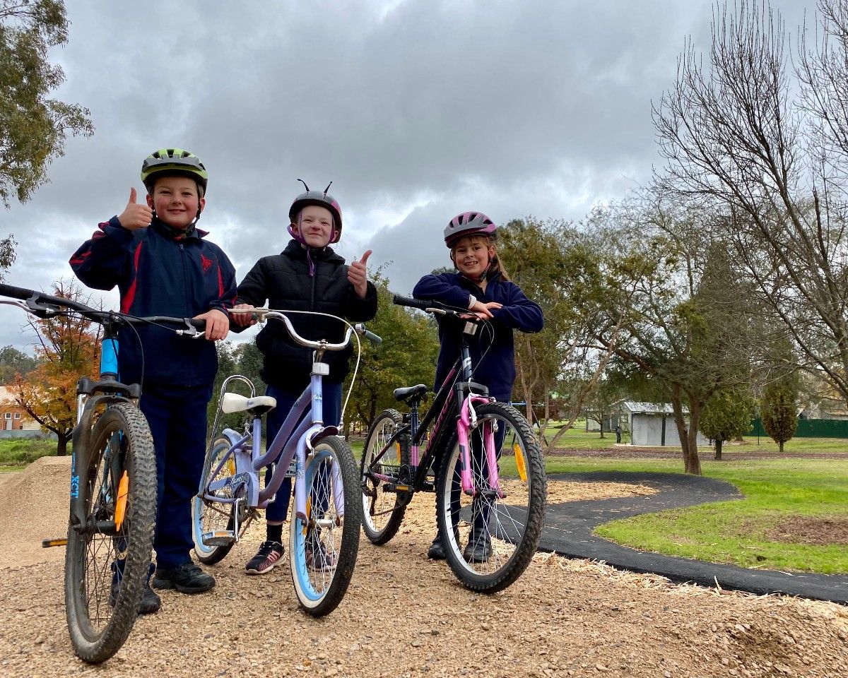 Three school children on bikes