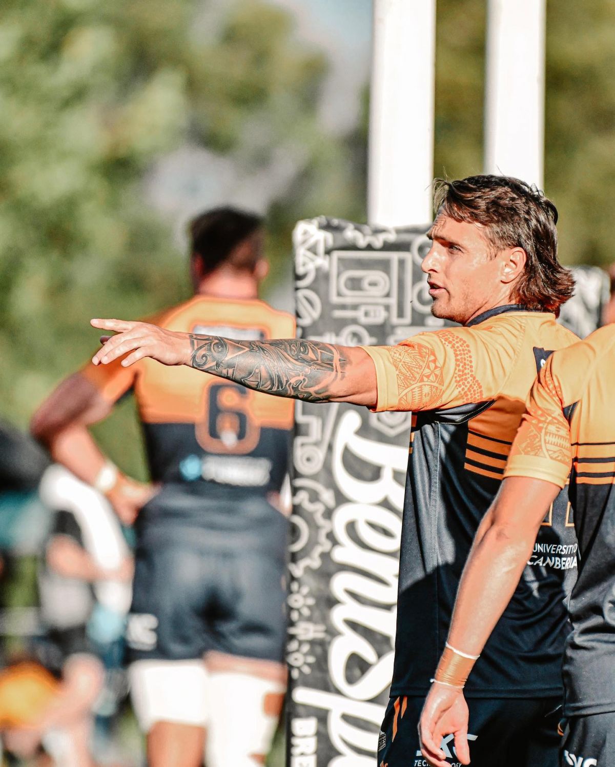 Act Brumbies Rugby players next to goal post