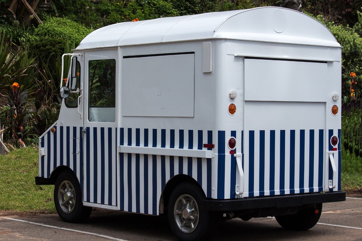Striped food truck parked in a car park