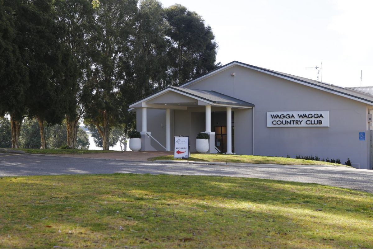 Exterior of Wagga Wagga Country Club with lake and trees in background