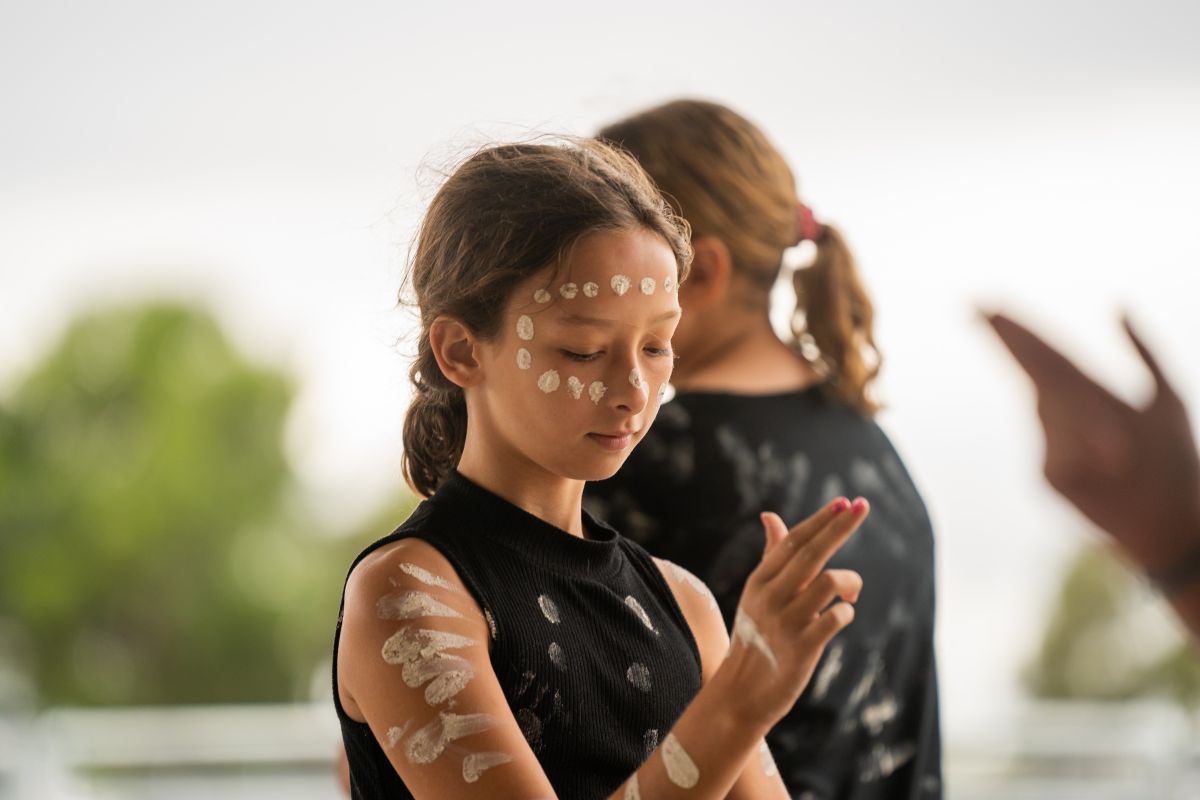 Young first nations female performing emu dance