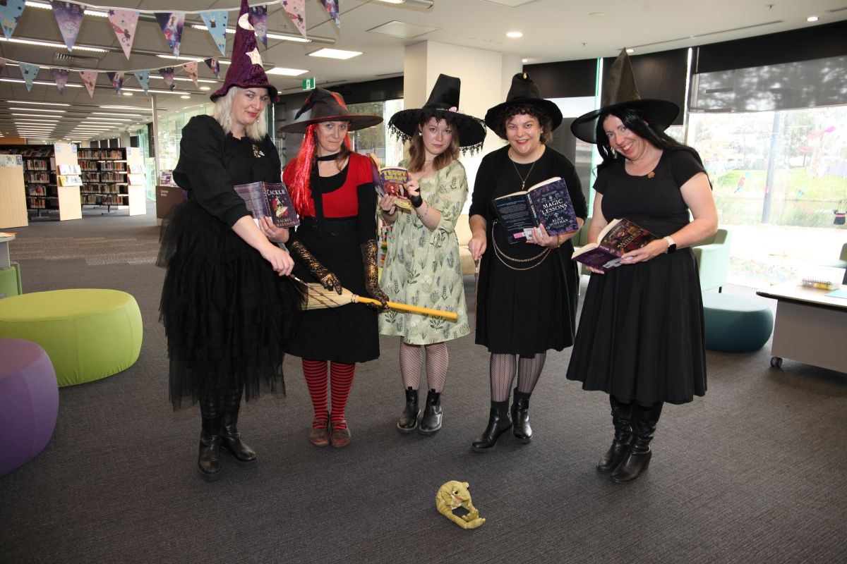 Librarians standing in a circle and dressed as witches for 2024 Book Week.