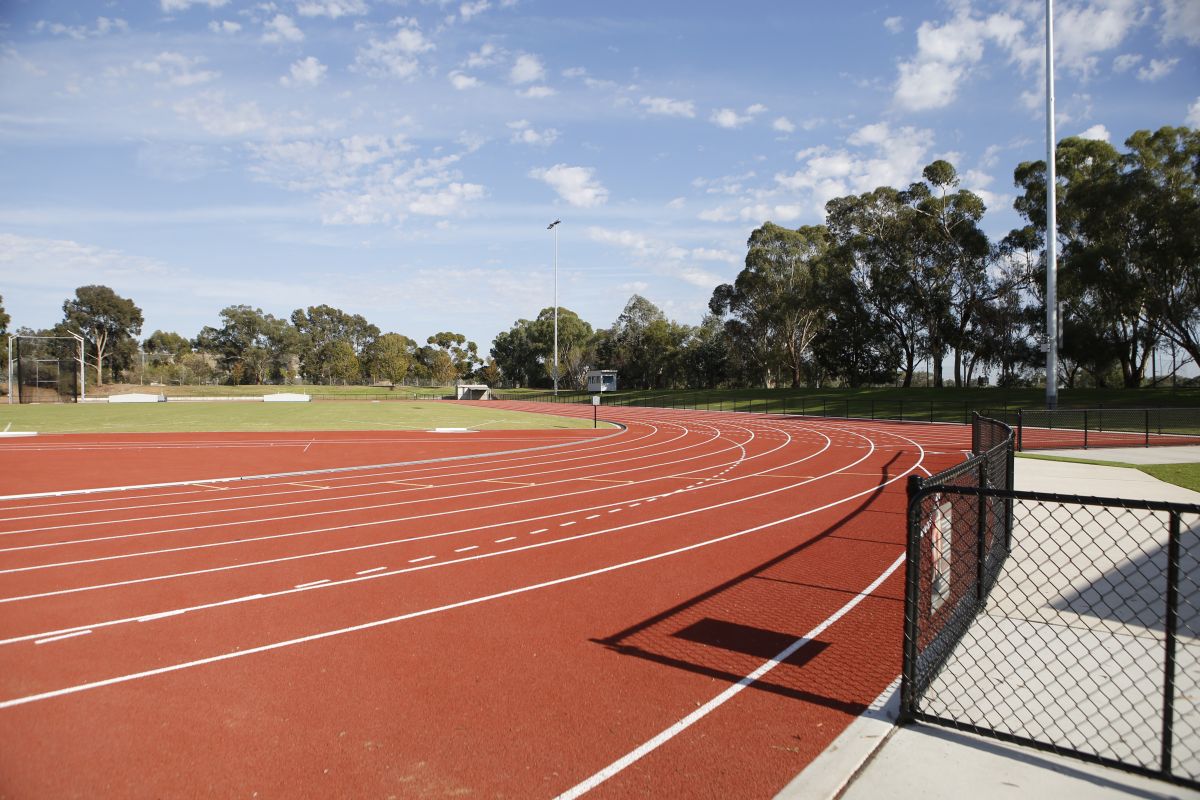 The red surface of an athletics track. 