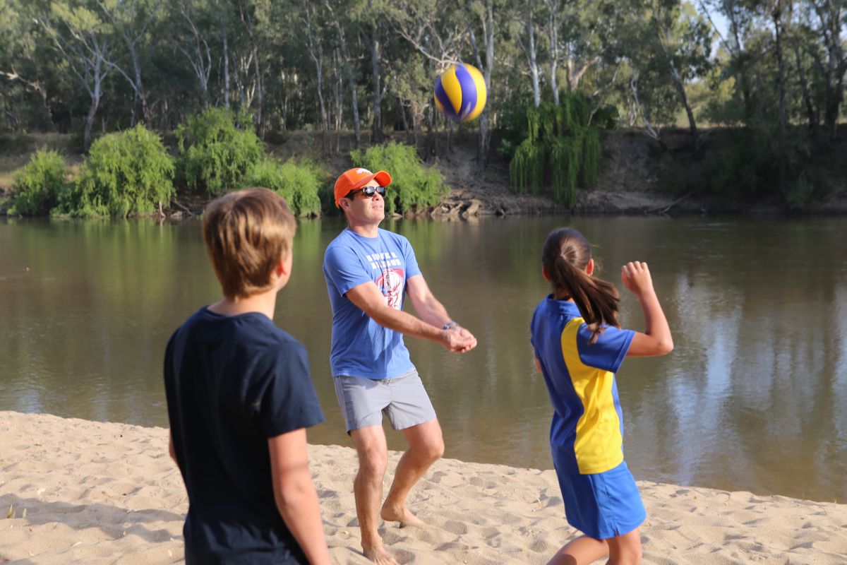 three people playing beach volleyball at Wagga Beach