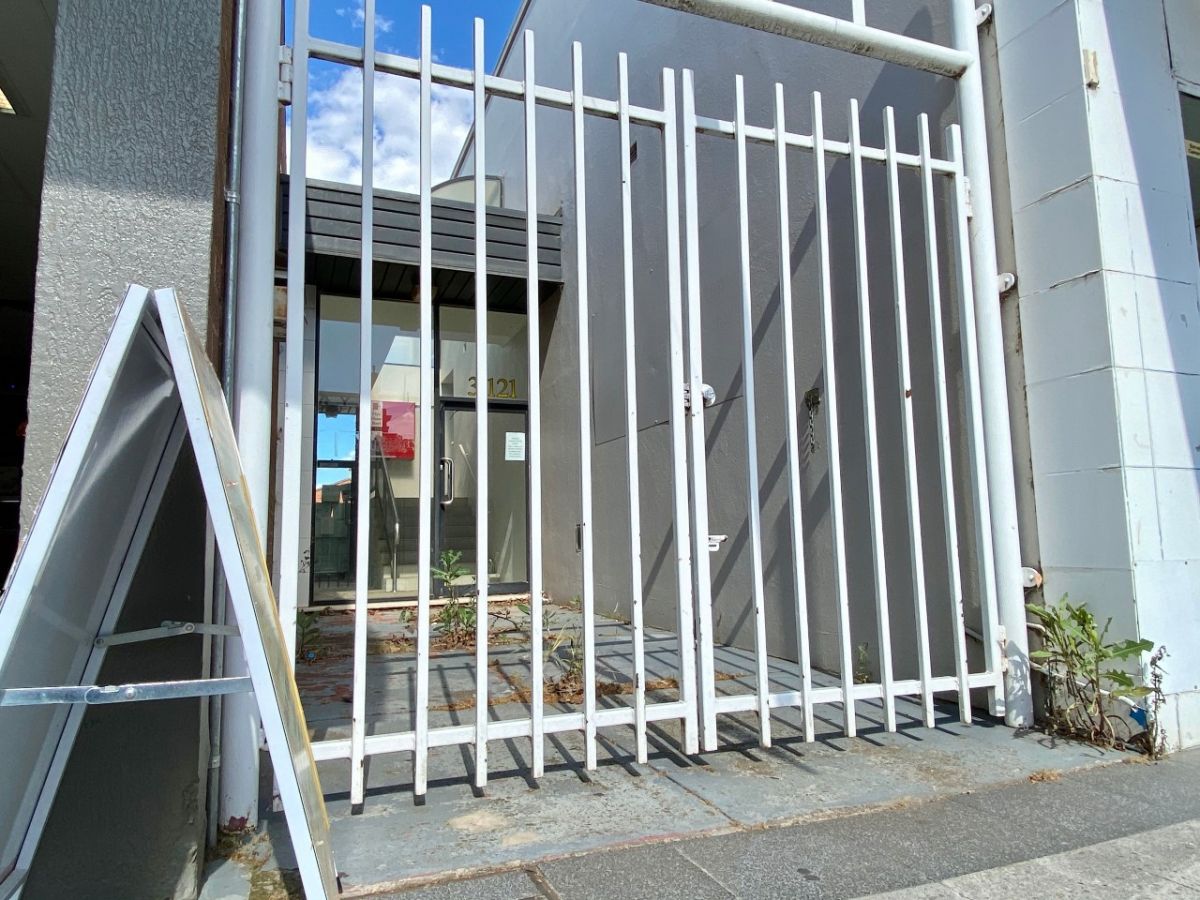 Closed gates in front of a small space