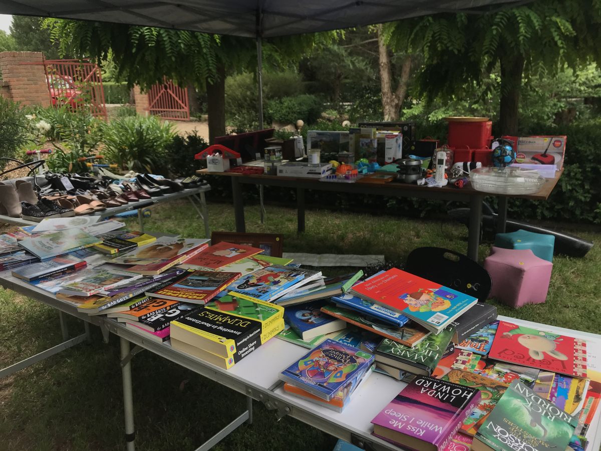 Household items on tables under cover for garage sale