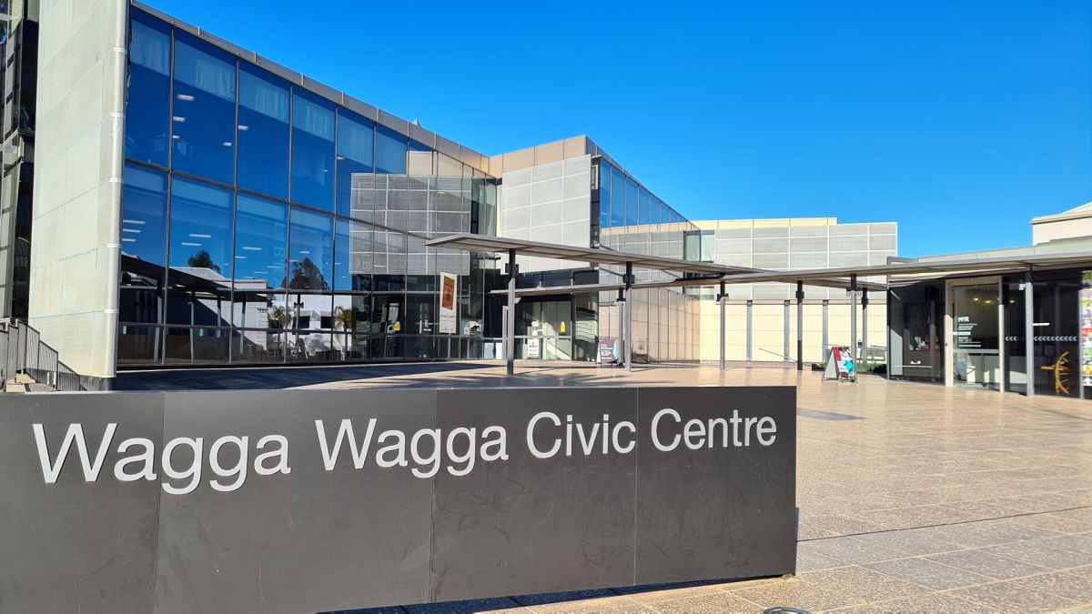 Glass and steel building with paved forecourt