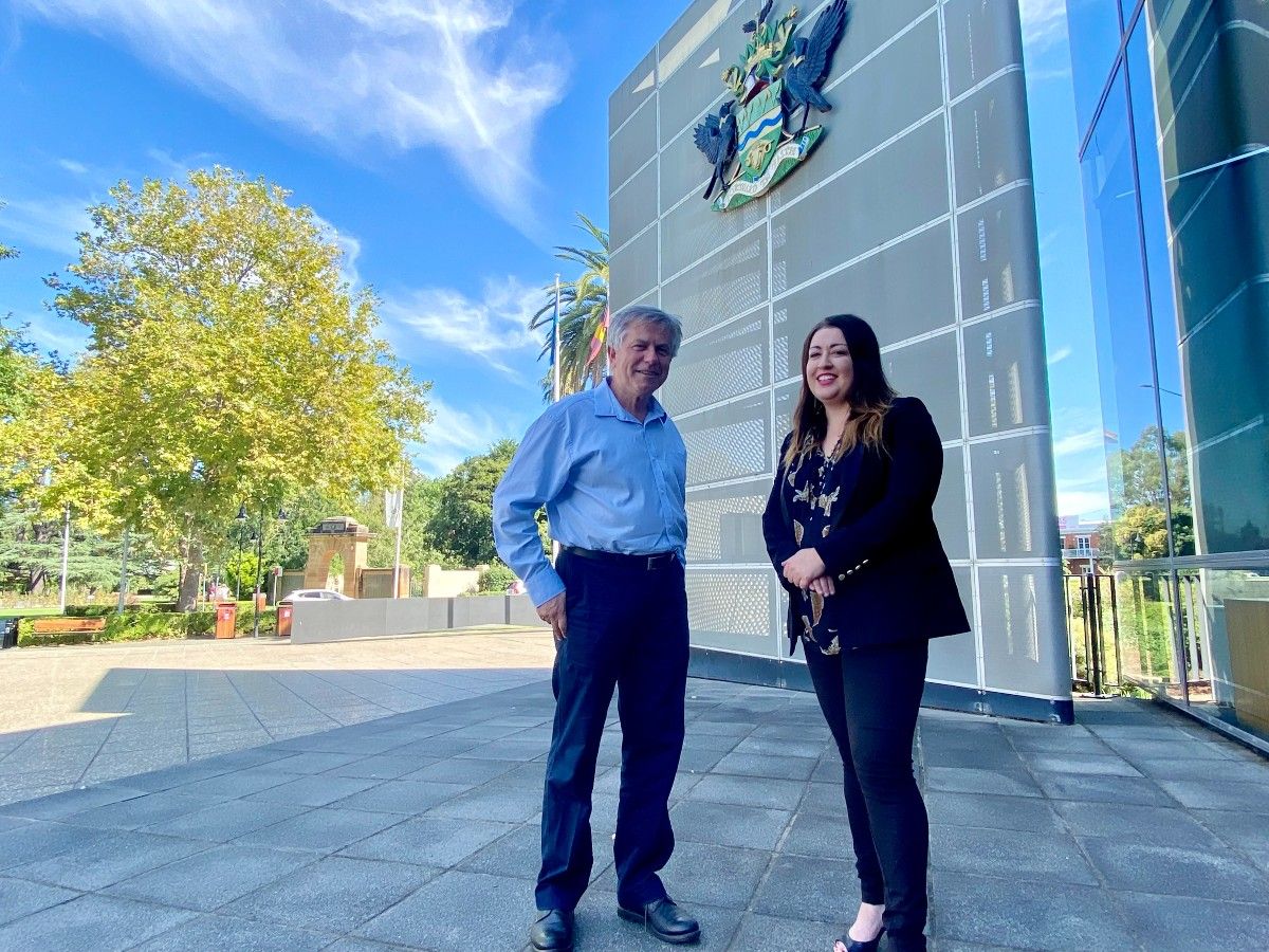 A man and woman standing in front of the Wagga Wagga Civic Centre
