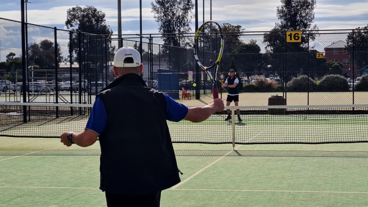 Two men playing tennis