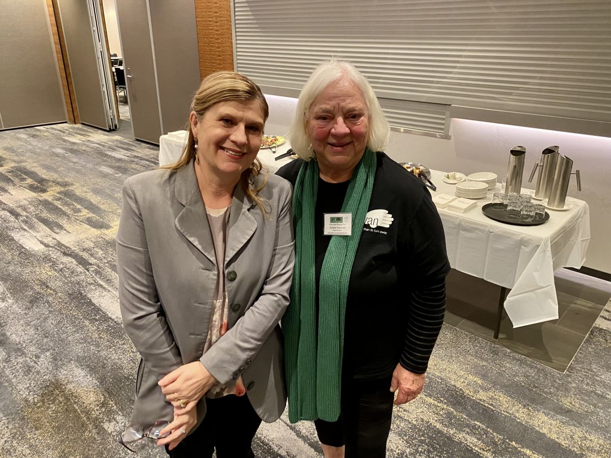 Two women standing beside each other, smiling