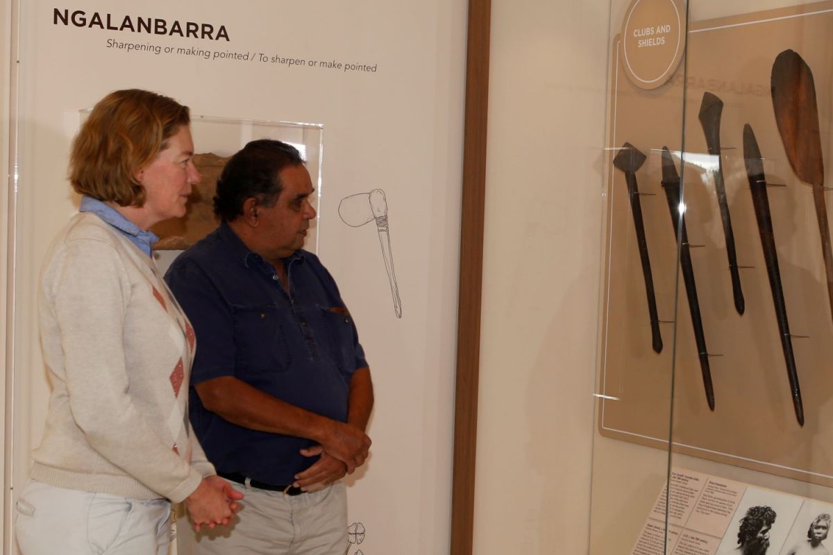 Two people looking at First Nations artefacts in a museum. 